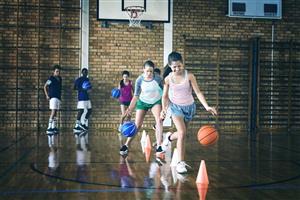 Teenage Boys And Girls Basketball Practice